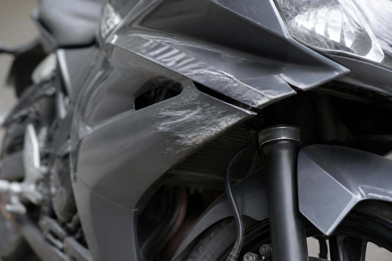 Damaged motorcycle shown cleanly in a professional setting